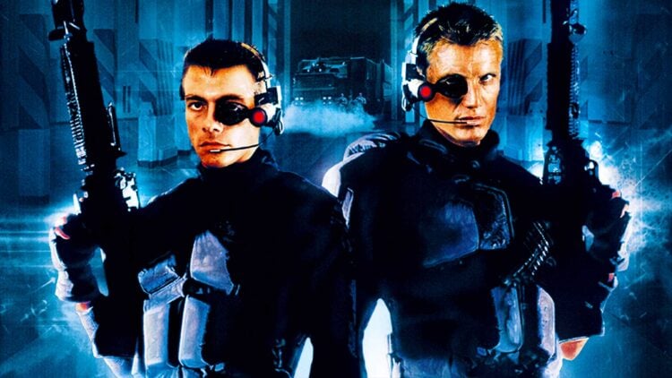 Jean-Claude Van Damme and Dolph Lundgren as reanimated soldiers in Universal Soldier, armed and facing forward against a blue sci-fi backdrop