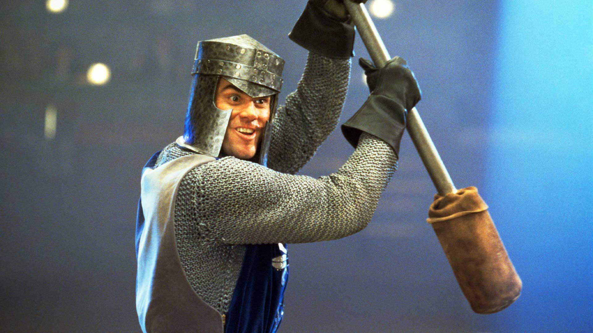 Jim Carrey as Chip Douglas in full chain mail armour wielding a padded mace during the Medieval Times fight scene in The Cable Guy (1996)