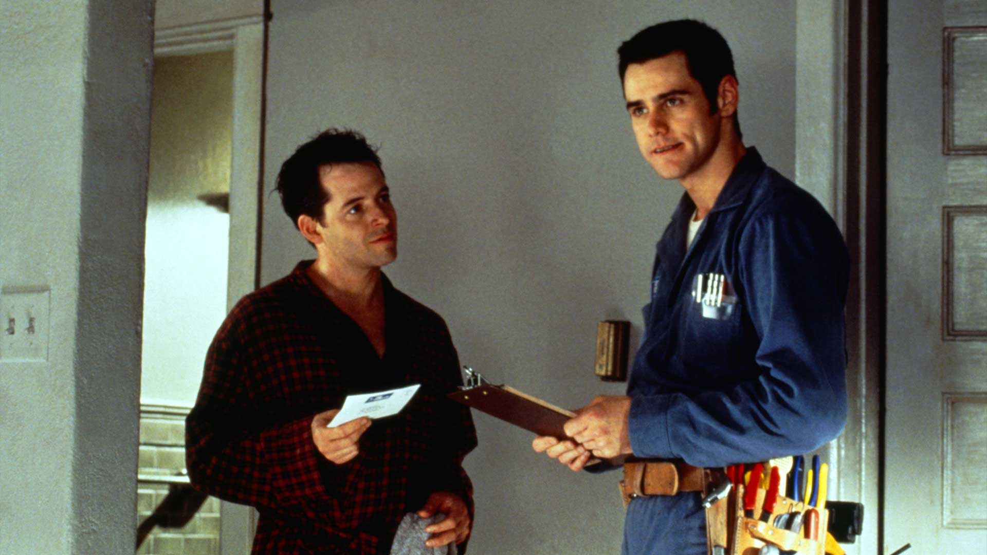 Matthew Broderick as Steven and Jim Carrey as Chip Douglas at the front door in The Cable Guy (1996), Chip in his cable technician uniform holding a clipboard