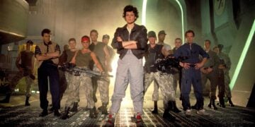Sigourney Weaver as Ripley with the Colonial Marines squad in a promotional photo for Aliens (1986)