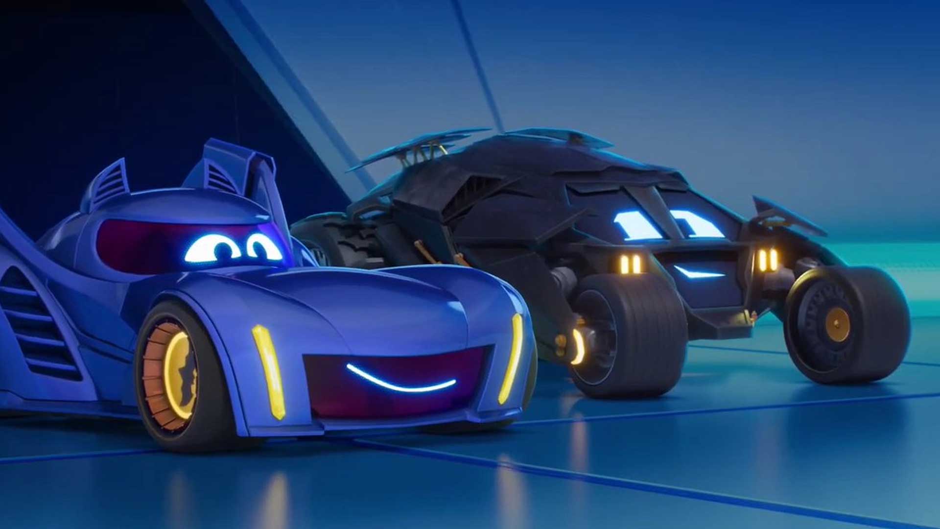 Bam the Batmobile and the Tumbler-style vehicle side by side in the Batwheels garage, both with glowing blue eyes