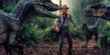 Sam Neill as Dr. Alan Grant flanked by two Velociraptors in Jurassic Park III