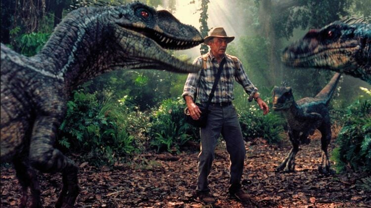 Sam Neill as Dr. Alan Grant flanked by two Velociraptors in Jurassic Park III