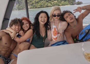Kathryn Newton, Lana Condor, and castmates smiling together on a boat in The Devil's Mouth