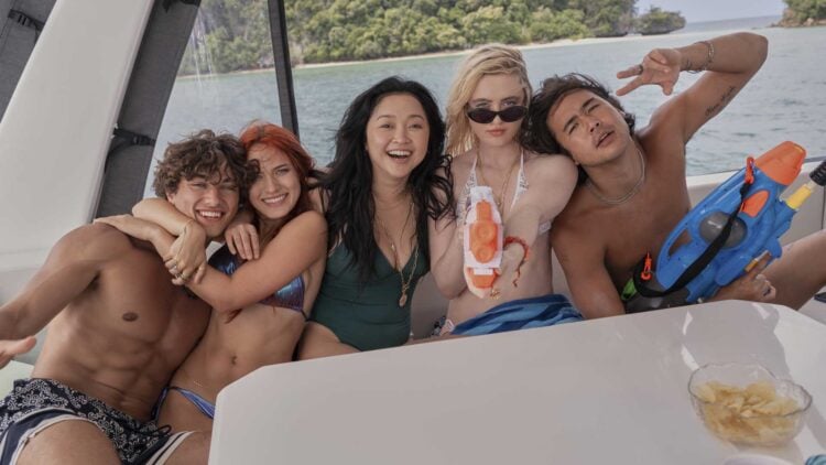 Kathryn Newton, Lana Condor, and castmates smiling together on a boat in The Devil's Mouth