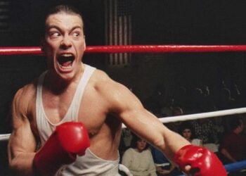 Jean-Claude Van Damme as Ivan "the Russian" Kraschinsky, gloves raised and shouting in the boxing ring in No Retreat, No Surrender