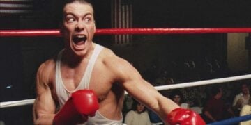 Jean-Claude Van Damme as Ivan "the Russian" Kraschinsky, gloves raised and shouting in the boxing ring in No Retreat, No Surrender