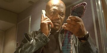 Samuel L. Jackson holds a snake while on the phone in a scene from Snakes on a Plane