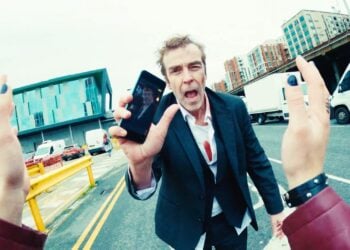 Karl Davis showing his phone in Bad Day at the Office